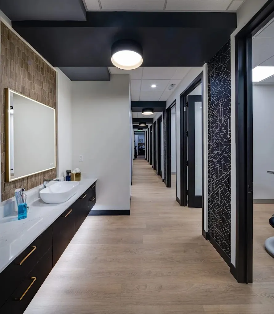 Hallway inside the Oak Tree Dental office, with treatment rooms off a wood-floored corridor